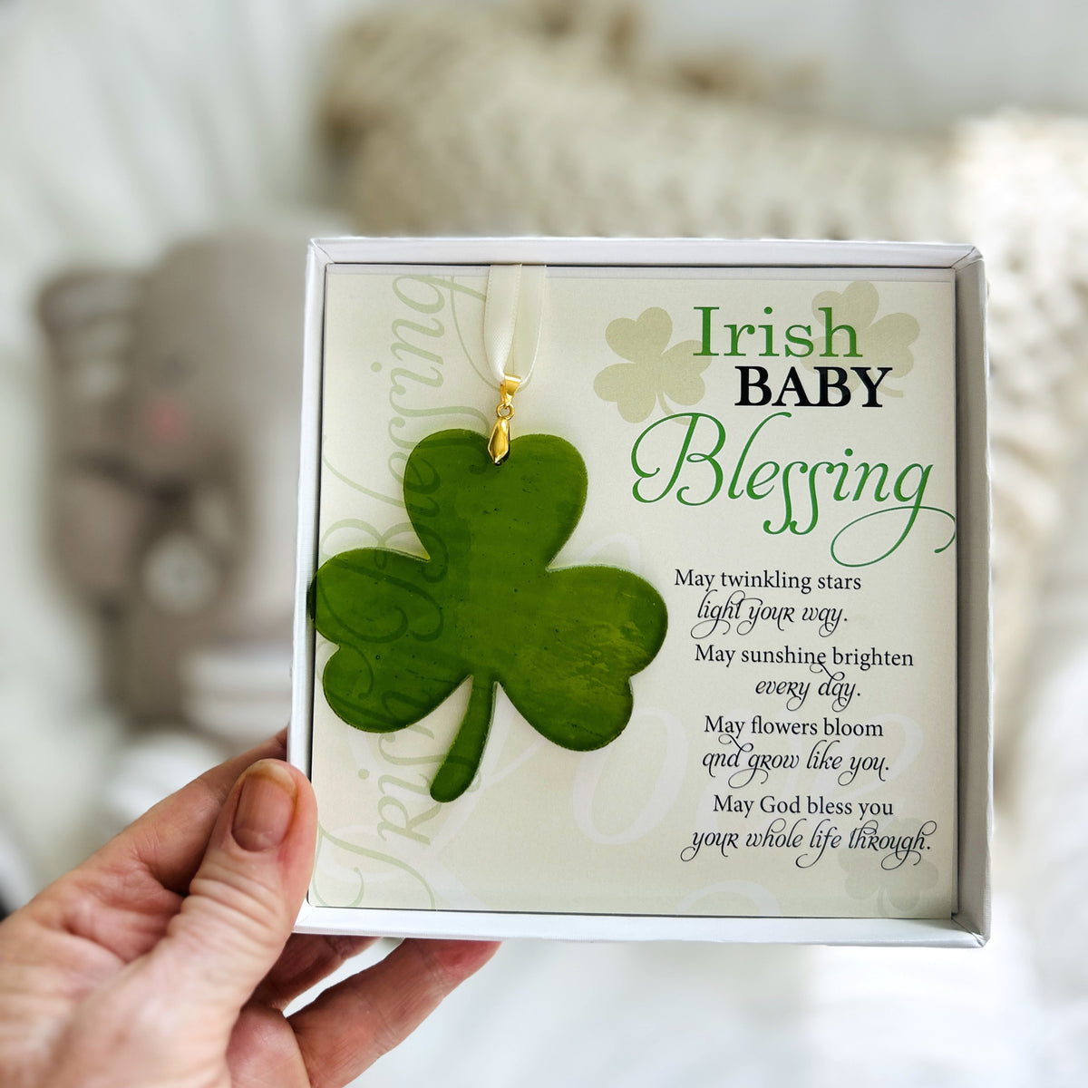 Irish Baby Blessing gift being held in a hand.