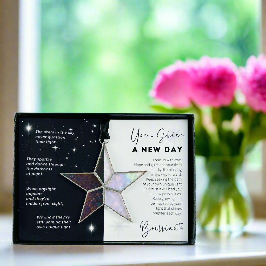 Handmade 4&quot; clear iridescent stained glass star with silver edging, packaged with &quot;You + Shine A New Day&quot; sentiment in black gift box with clear lid.