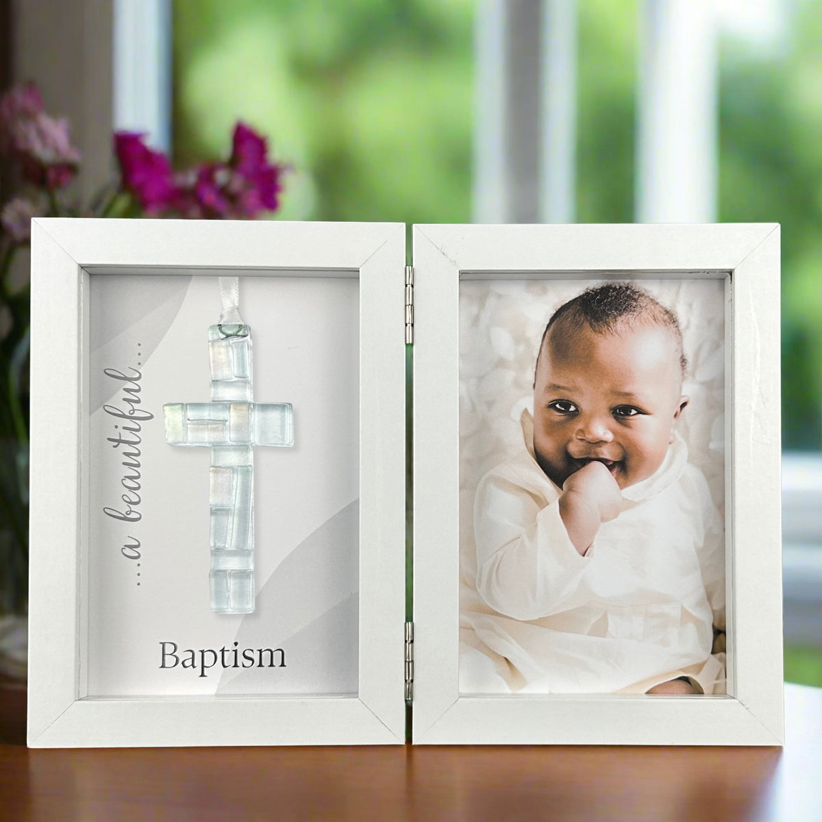 Baptism shadow box frame standing open on a table.