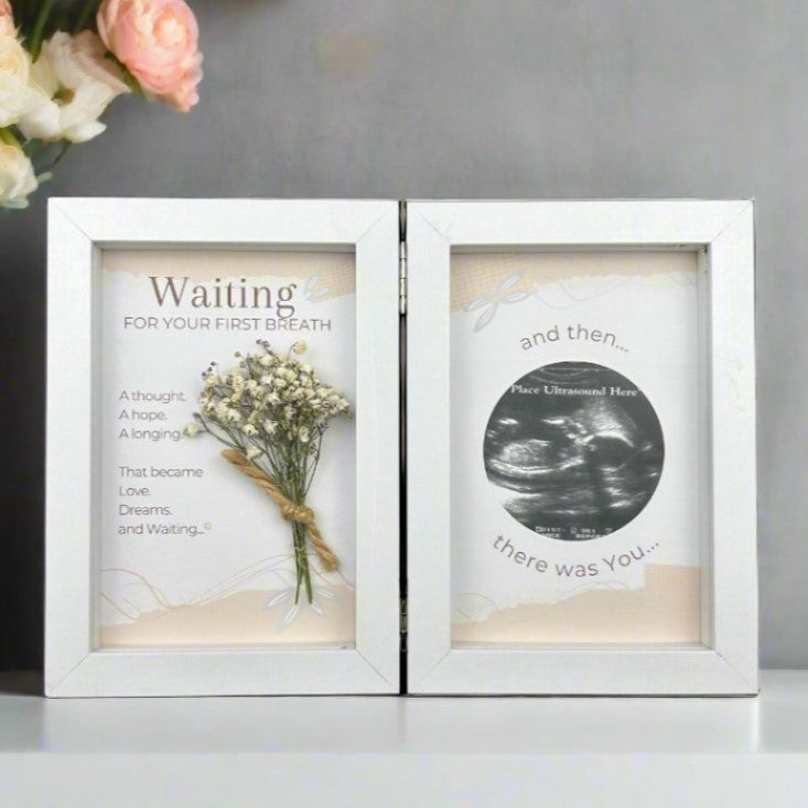 Ultrasound frame with sentiment and dried baby&#39;s breath on one side and artwork with a 2 1/2&quot; opening for sonogram photo on the other side.