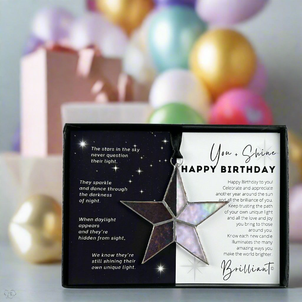 Handmade 4&quot; clear iridescent stained glass star with silver edging, packaged with &quot;You + Shine Happy Birthday&quot; sentiment in black gift box with clear lid.