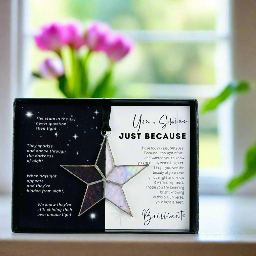 Handmade 4&quot; clear iridescent stained glass star with silver edging, packaged with &quot;You + Shine Just Because&quot; sentiment in black gift box with clear lid.