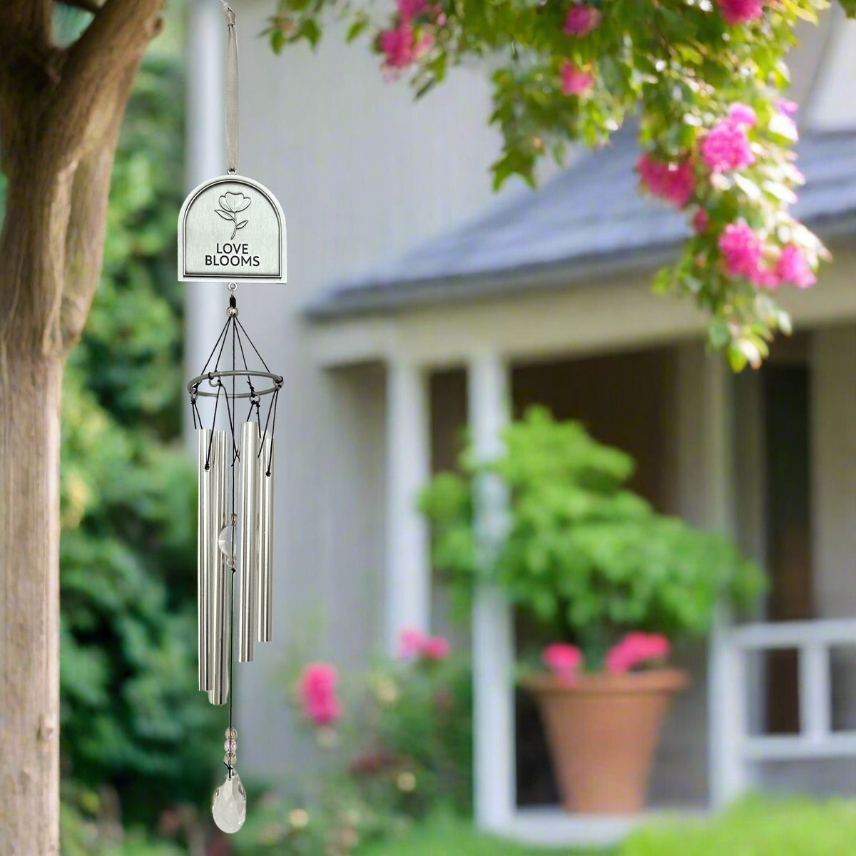 Love Blooms windchime hanging in a tree.