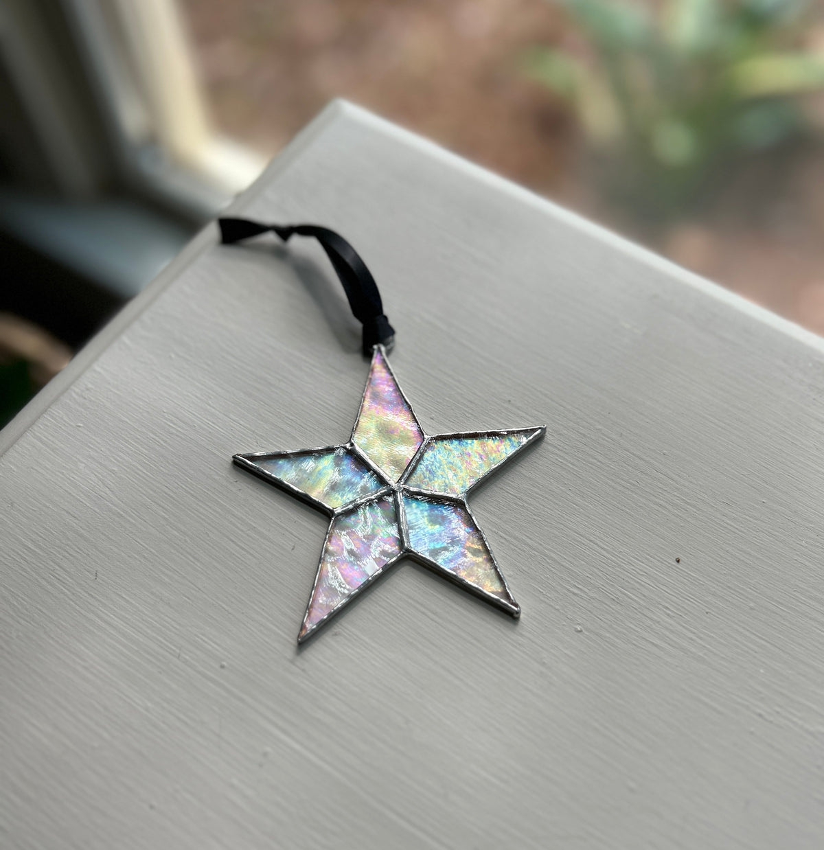 Star laying on desk showing the array of colors from light shining on the star.