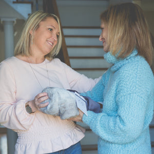 4 of 11:Two women exchanging the comfort blanket.