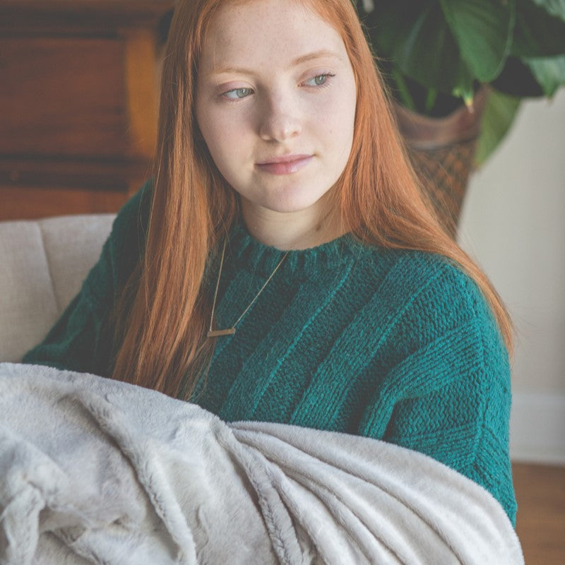 Girl snuggling in the blanket.