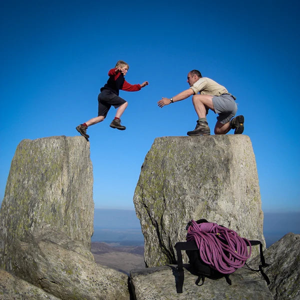 A father and son climbing rocks - Click to shop our Father's Day Gifts