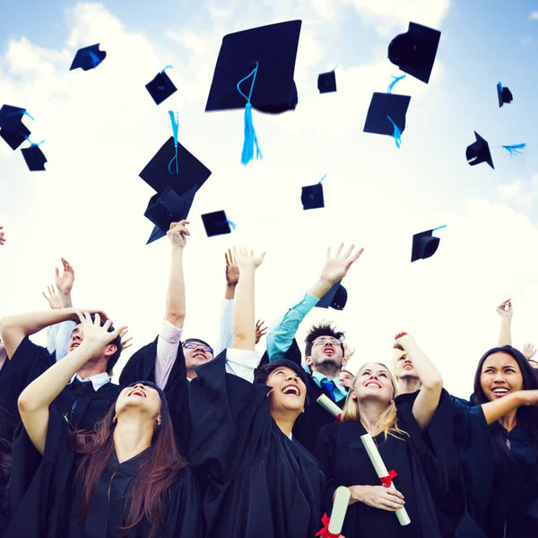 Graduates throwing their caps in the air - Click to shop our Graduation Gifts